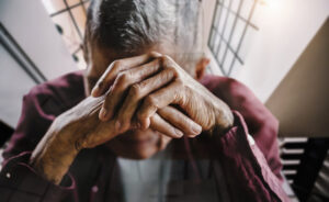 Seniors and Mental Health - senior man covering his face with his hands